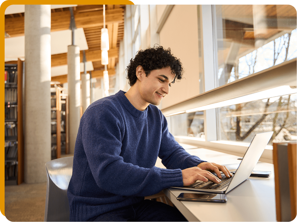 Man studying by large windows