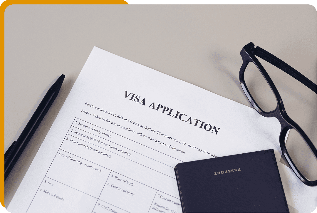 Visa paperwork on desk with accessories