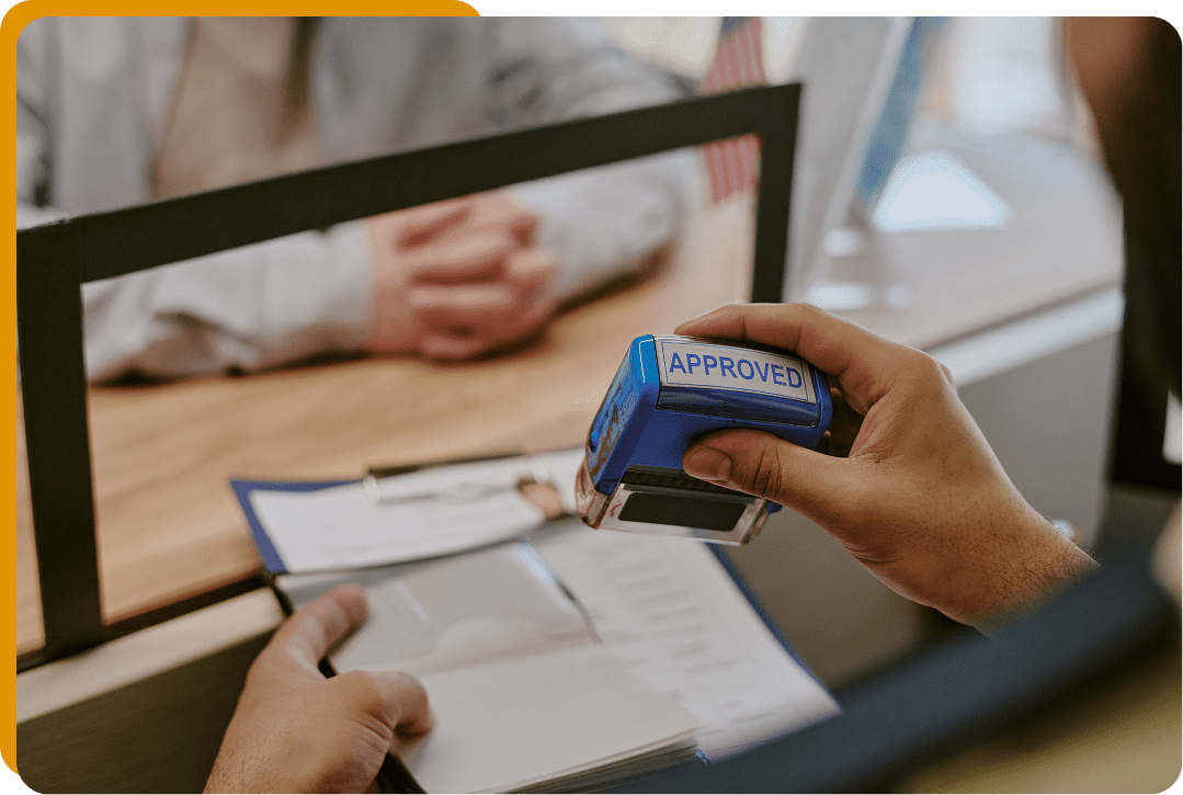 Approved stamp on document at desk