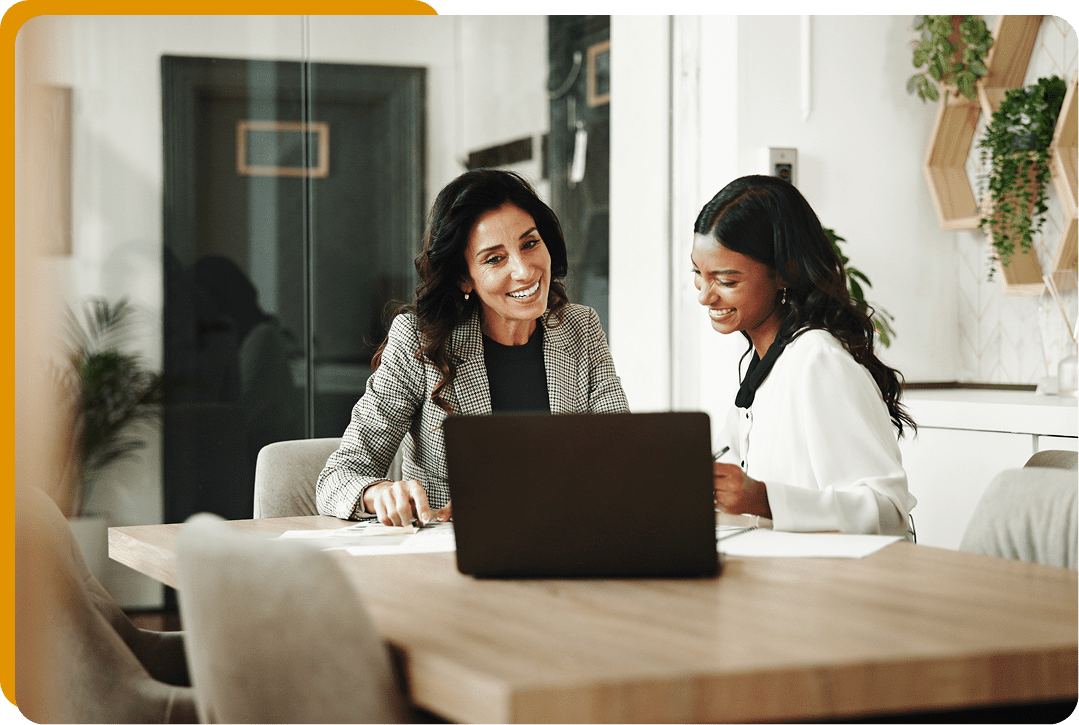 Colleagues collaborating with a laptop.