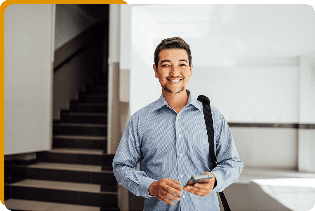 Person in blue shirt holding smartphone