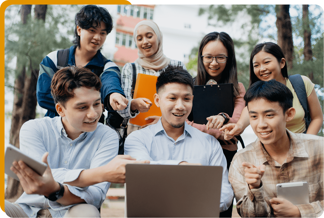 Diverse students gathered around a laptop