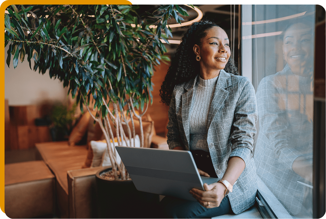Woman with laptop by window