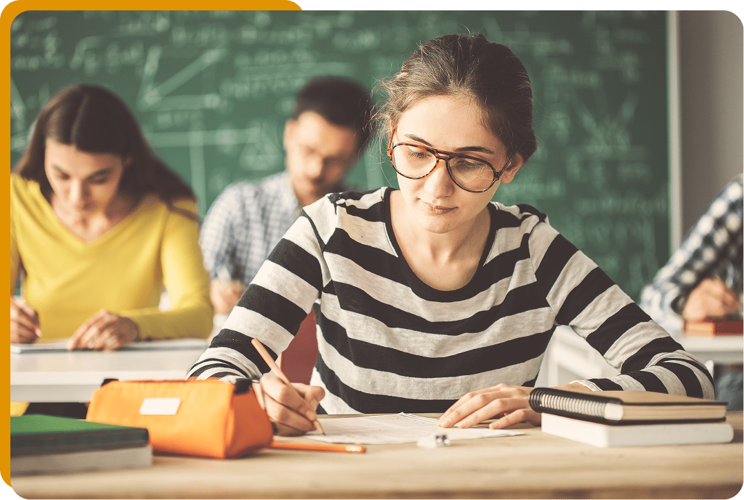 Focused student taking notes at desk